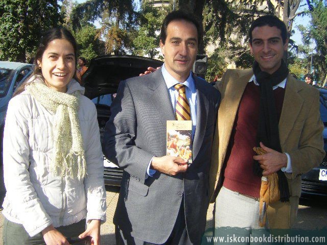 Sri Bhakti Das and Indira Devi Dasi Jahnava Distributing a Book to the Mayor of Santiago