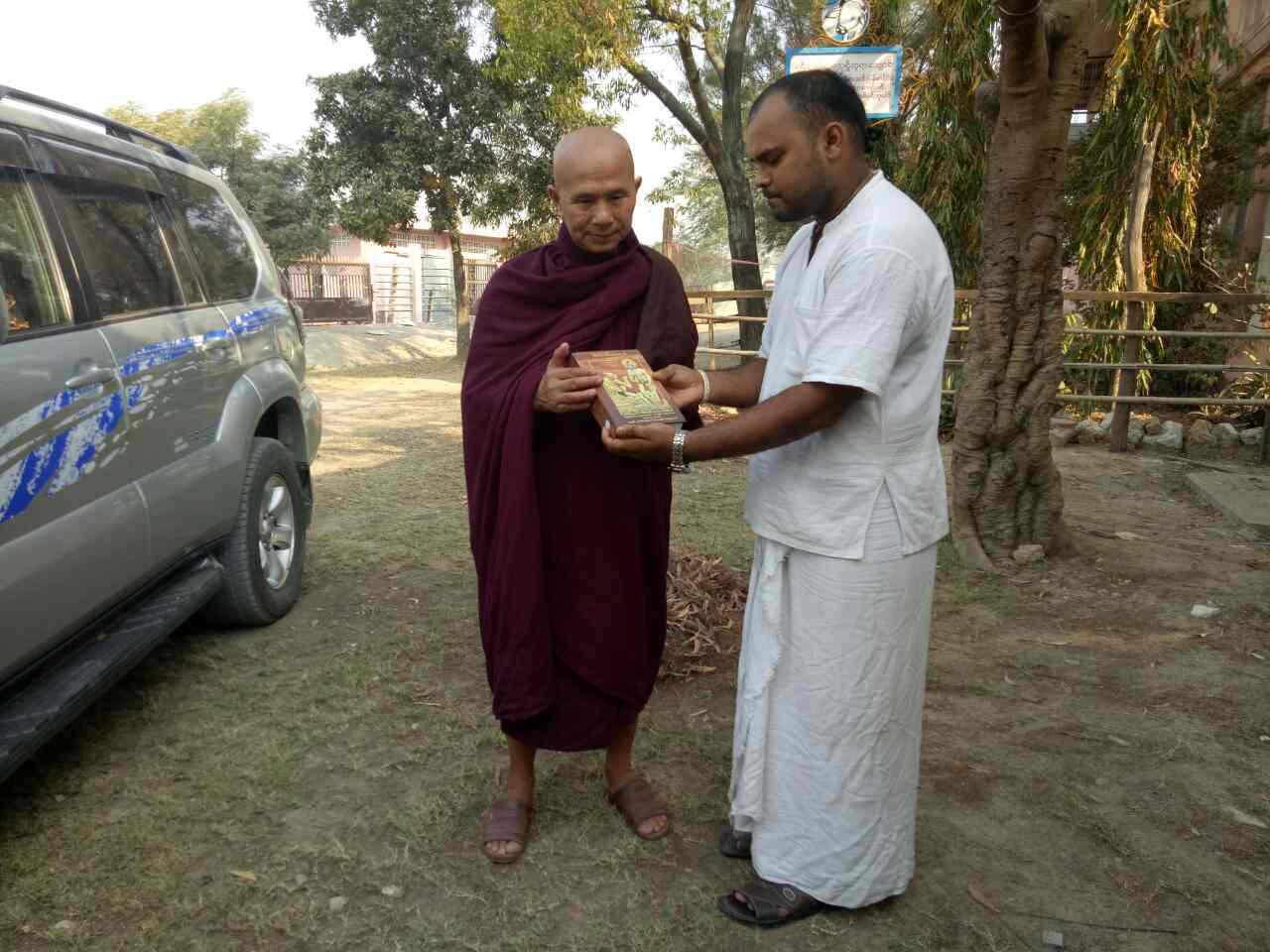 Famous Monk Sayadaw receiving Bhagavad Gita in Burmese by HG Lila Govinda prabhu