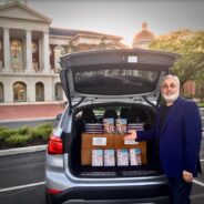 A devotee professor distributing books to his students