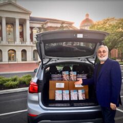 A devotee professor distributing books to his students